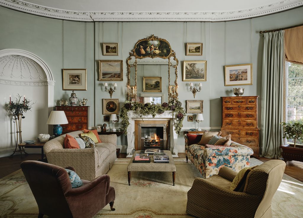 Image may contain Home Decor Lamp Plant Couch Furniture Art Painting Chair Rug Architecture Building and Indoors