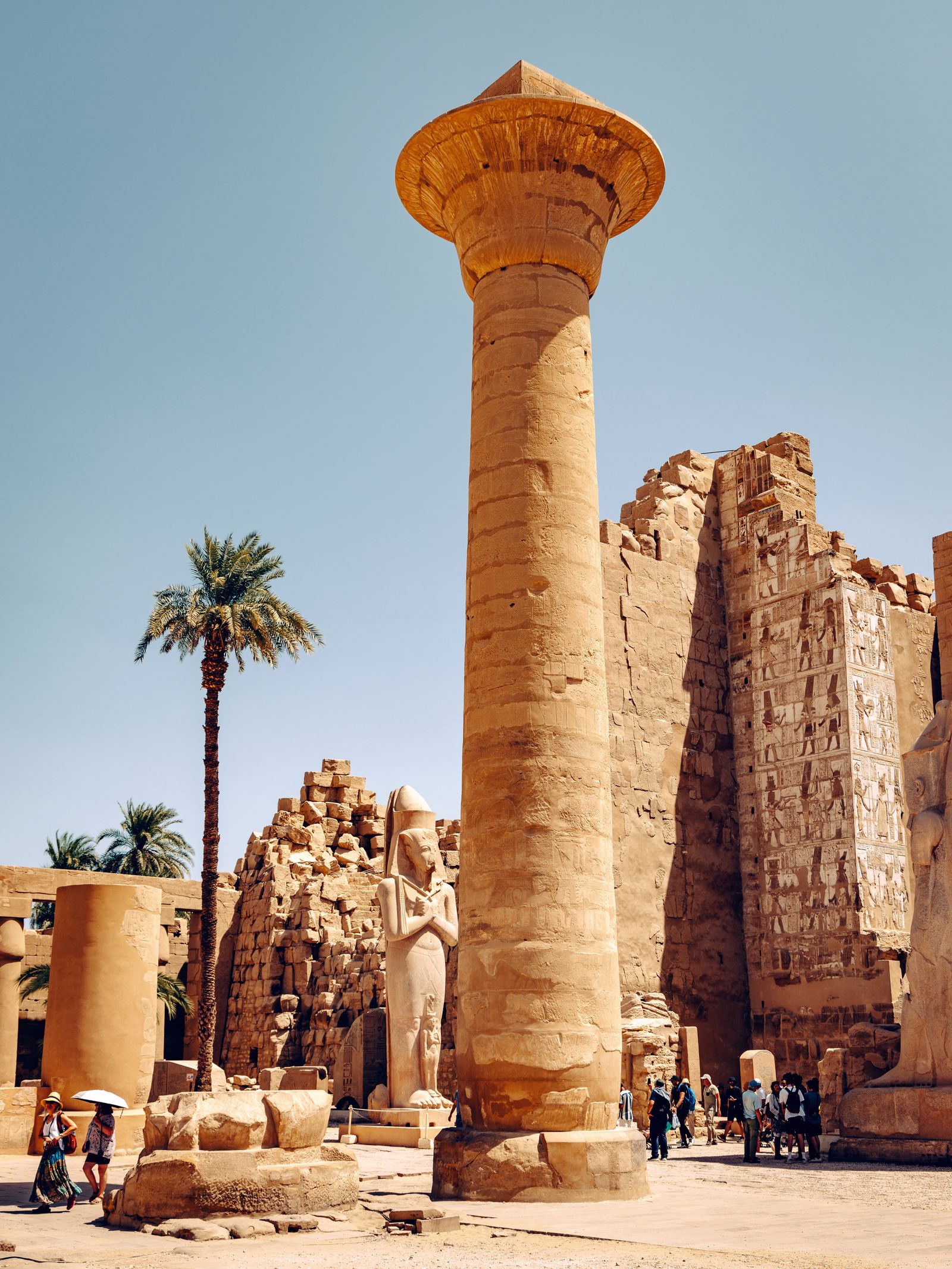 Image may contain Person Clothing Hat Accessories Bag Handbag Landmark and Temple of Luxor