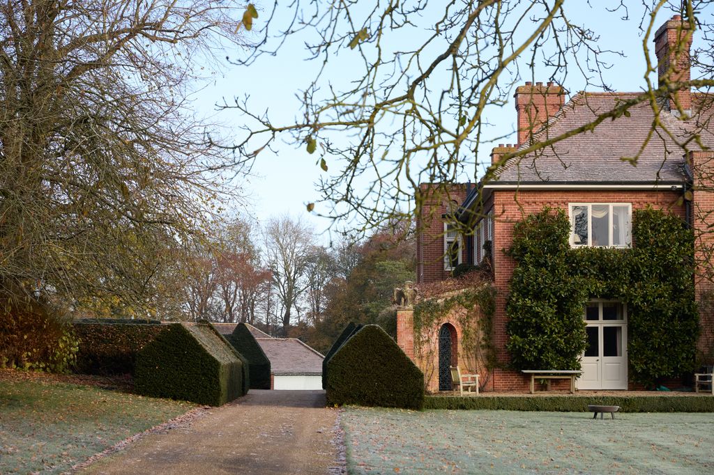 Image may contain Architecture Building Housing House Bench Furniture Outdoors Driveway Chair and Manor