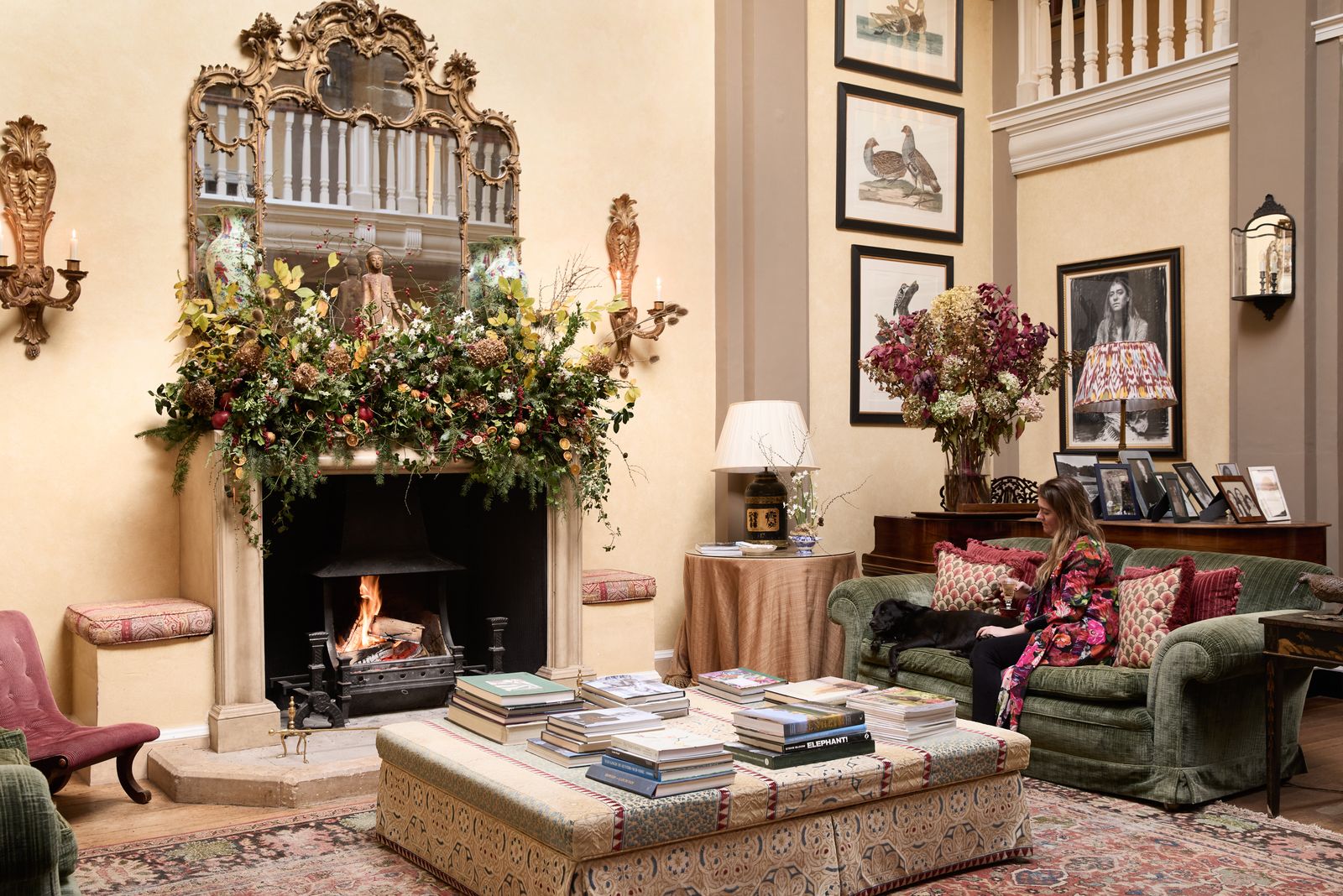 Image may contain Home Decor Couch Furniture Lamp Adult Person Chair Art Painting Fireplace Indoors and Desk