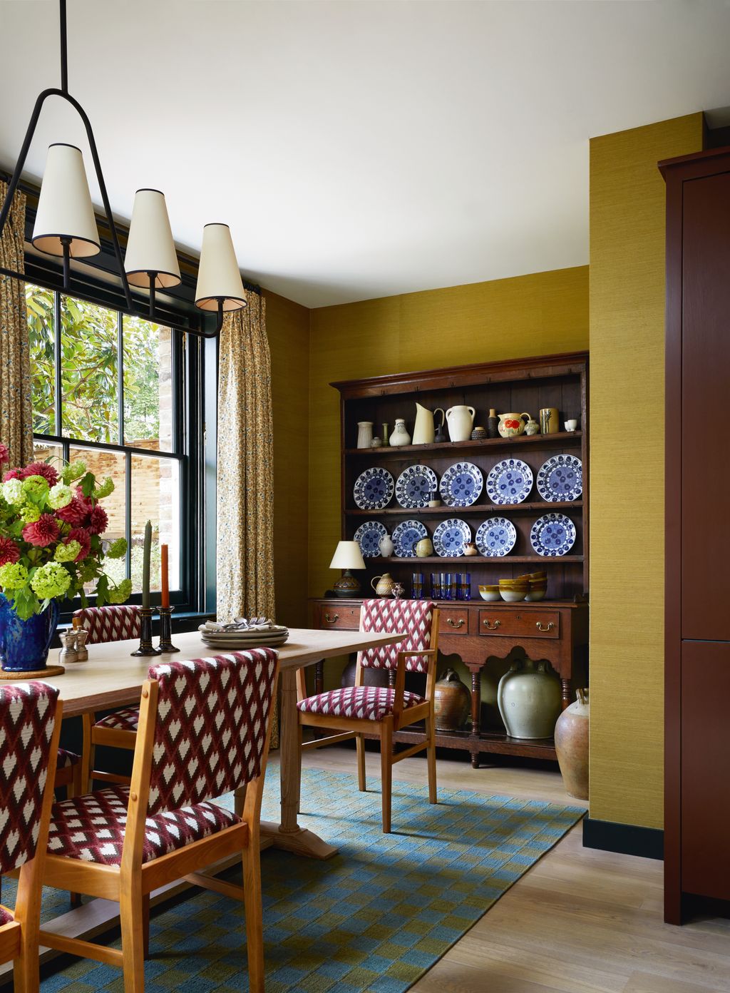 Image may contain Architecture Building Dining Room Dining Table Furniture Indoors Room Table and Lamp