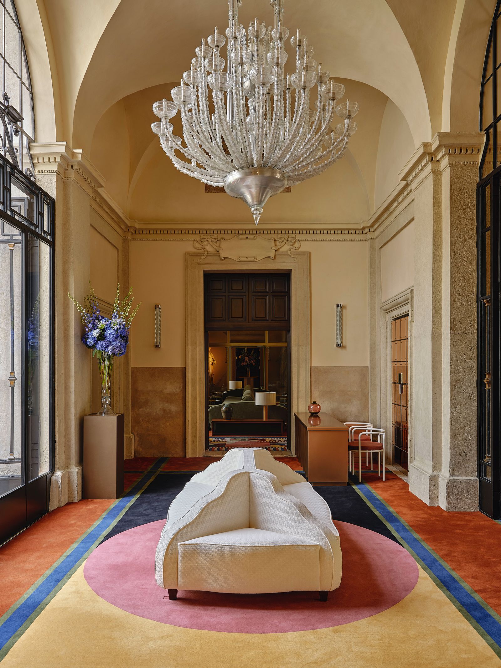 Image may contain Chandelier Lamp Home Decor Couch Furniture Chair Architecture Building Foyer Indoors and Person