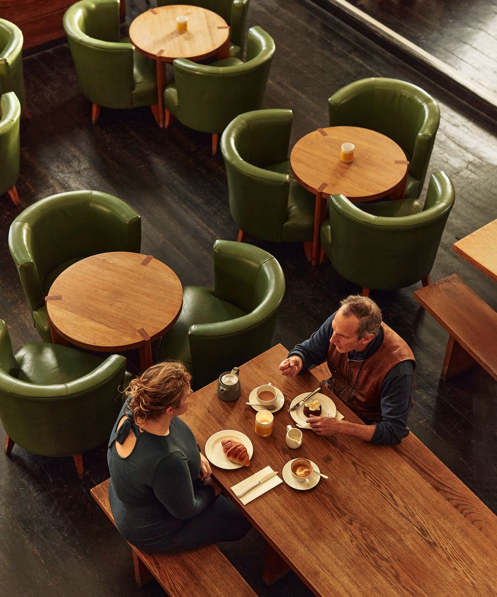 Image may contain Alain Taravella Indoors Restaurant Adult Person Cup Blade Knife Weapon Chair Furniture and Desk