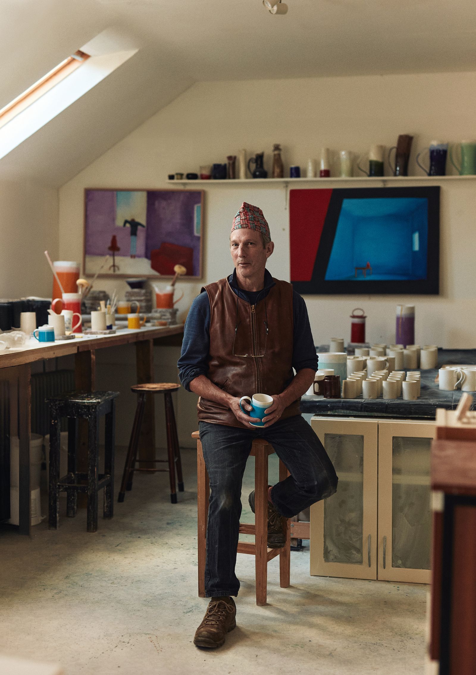 Image may contain Person Sitting Clothing Footwear Shoe Pants Adult Dining Table Furniture Table Cup and Face