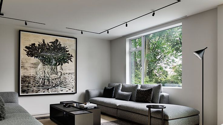 Image may contain: Lamp, Couch, Furniture, Home Decor, Architecture, Building, Indoors, Living Room, Room, Art, and Painting