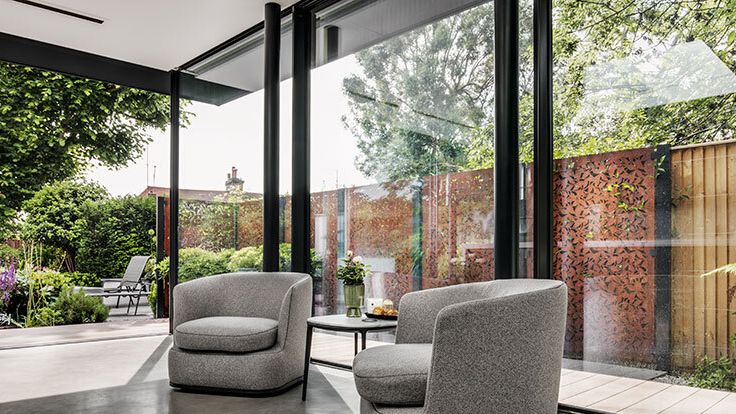 Image may contain: Indoors, Architecture, Building, Foyer, Furniture, Chair, and Couch