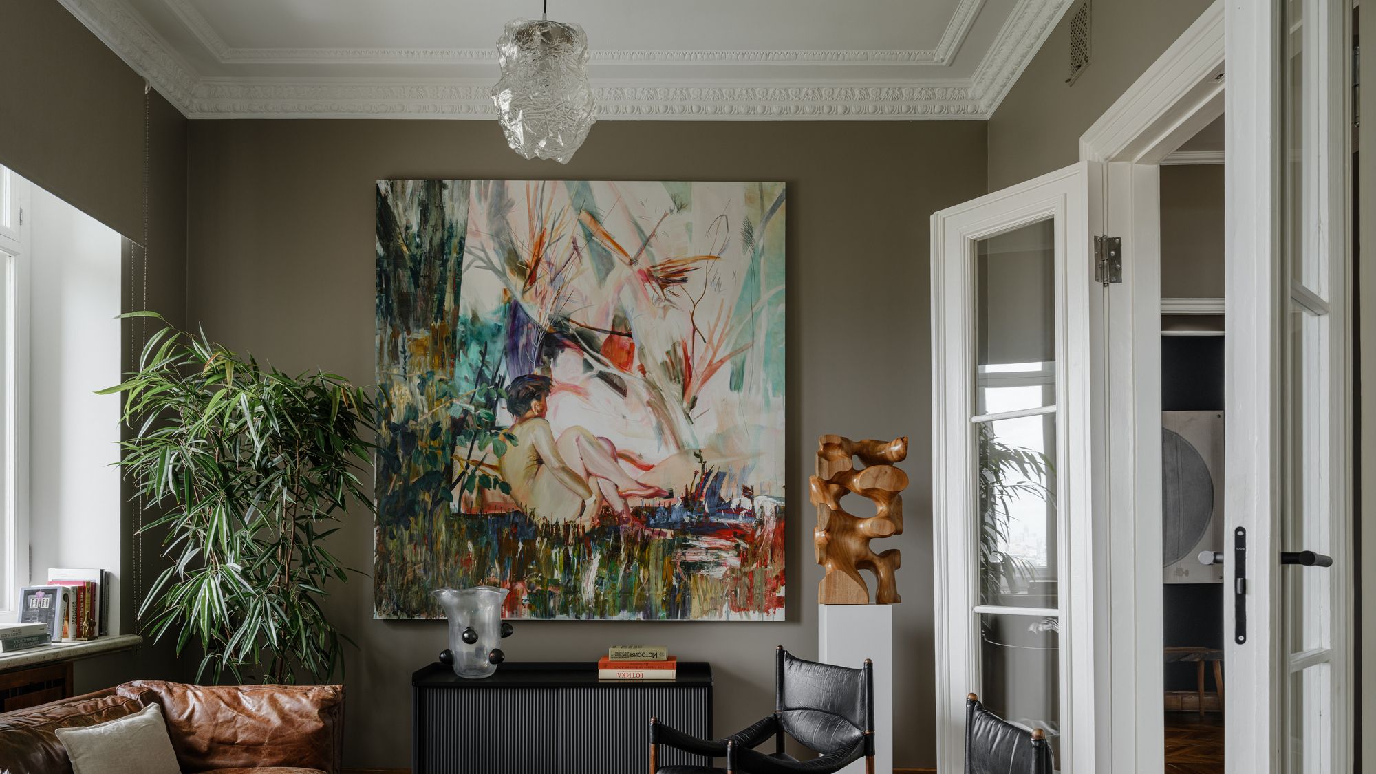 Image may contain: Home Decor, Chair, Furniture, Couch, Architecture, Building, Indoors, Living Room, Room, Lamp, and Art