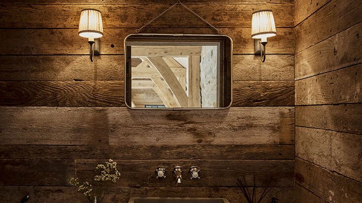 Image may contain: Indoors, Interior Design, Lamp, Sink, Wood Panels, Hardwood, Stained Wood, Wood, Sink Faucet, and Plant