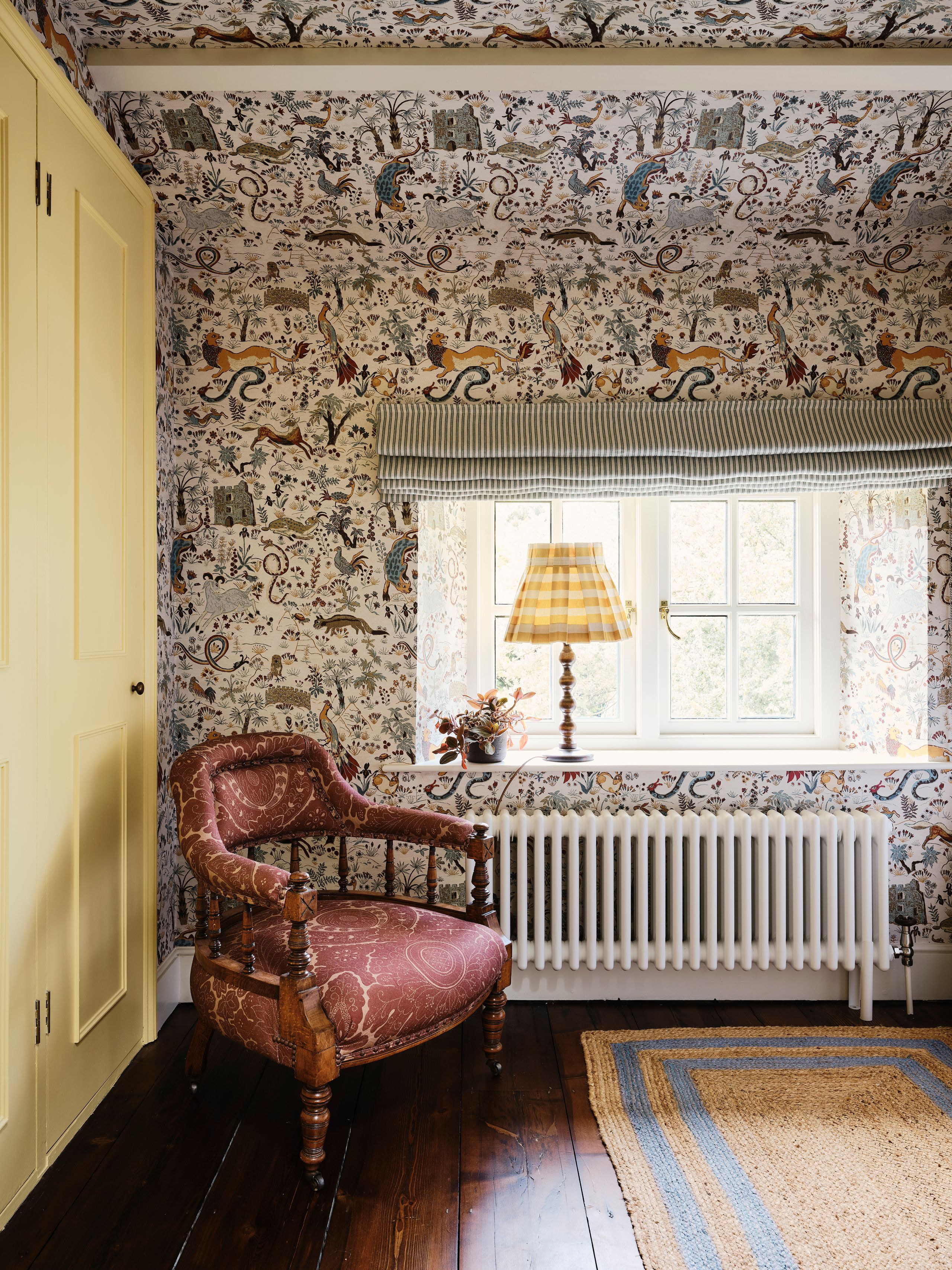 Image may contain: Lamp, Chair, Furniture, Indoors, Interior Design, Home Decor, Rug, and Plant