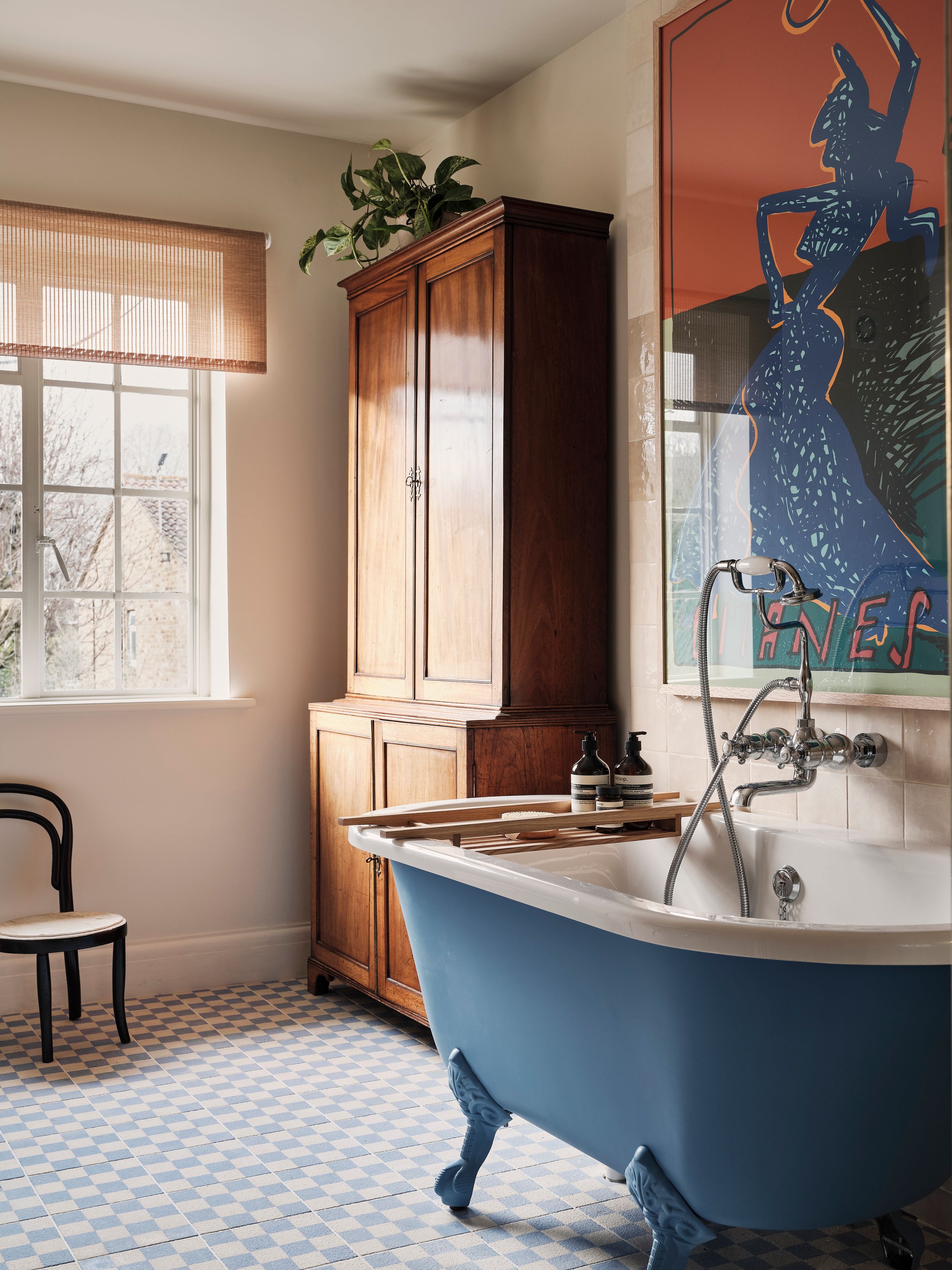 Image may contain: Indoors, Interior Design, Sink, Sink Faucet, Chair, Furniture, Plant, Bathing, Bathtub, Person, and Tub