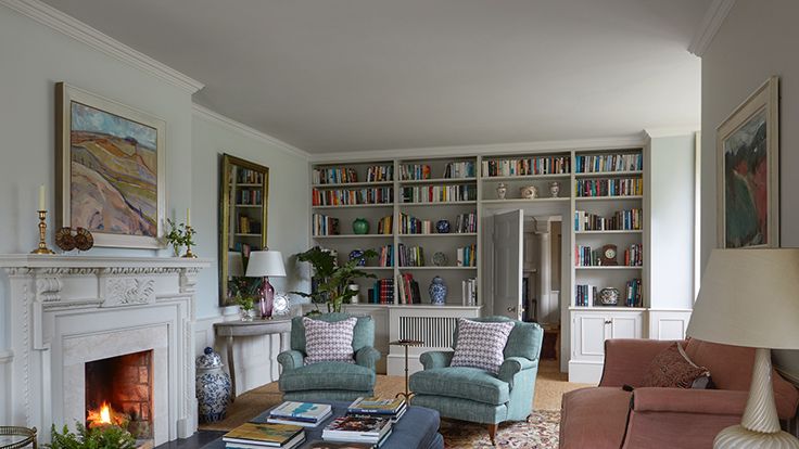 Image may contain: Architecture, Building, Furniture, Indoors, Living Room, Room, Lamp, Home Decor, Fireplace, Couch, and Art