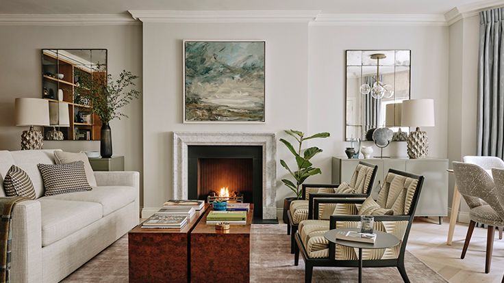 Image may contain: Home Decor, Furniture, Table, Coffee Table, Lamp, Plant, Couch, Architecture, Building, and Indoors