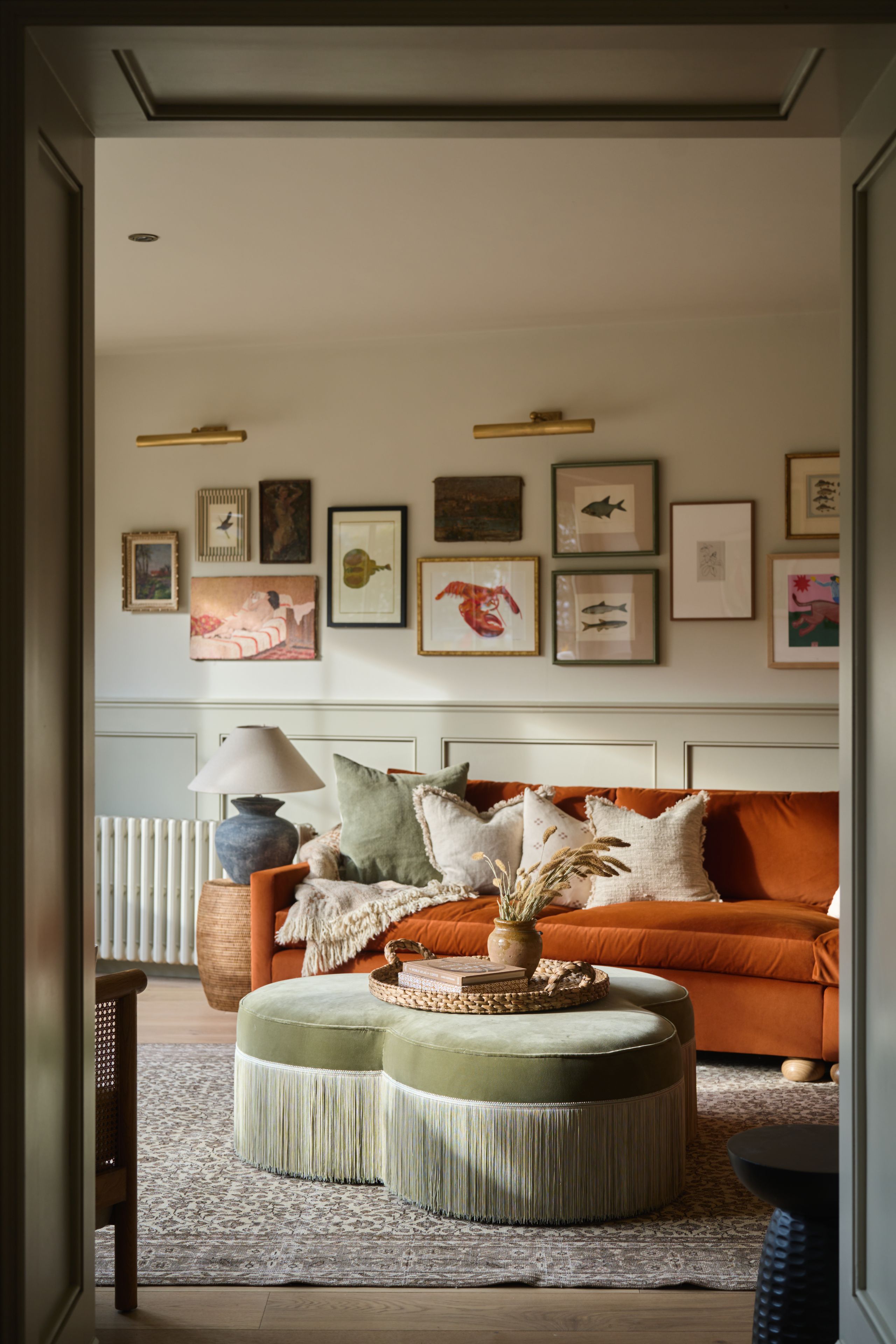 Image may contain: Home Decor, Lamp, Furniture, Cushion, Architecture, Building, Indoors, Living Room, Room, Rug, and Couch