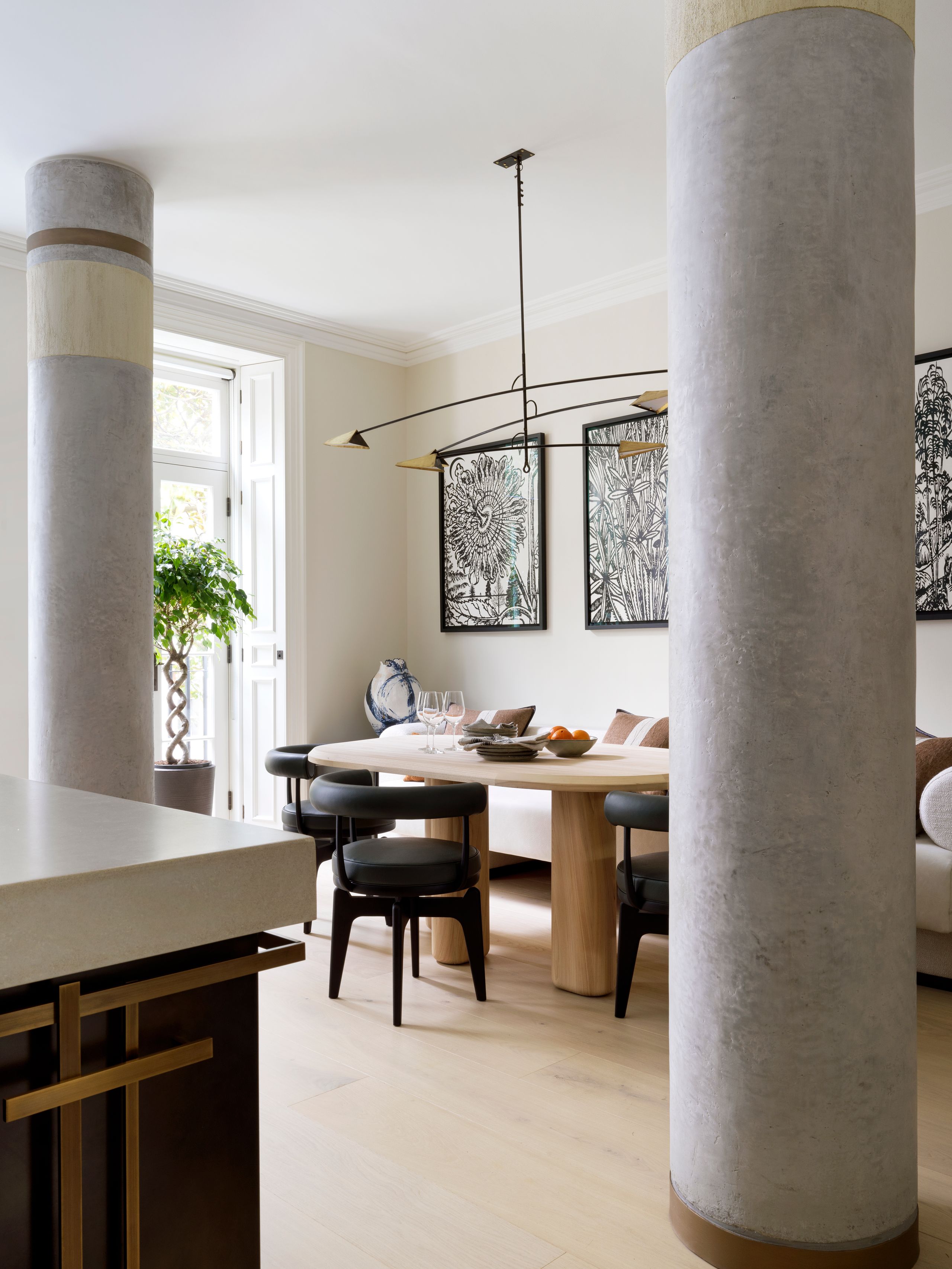 Image may contain: Architecture, Building, Dining Room, Dining Table, Furniture, Indoors, Room, Table, Plant, and Chair