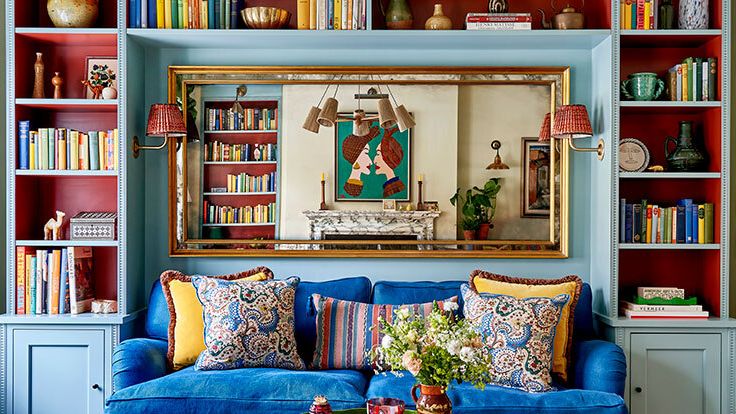 Image may contain: Home Decor, Couch, Furniture, Lamp, Bookcase, Cup, Architecture, Building, Indoors, Living Room, and Room