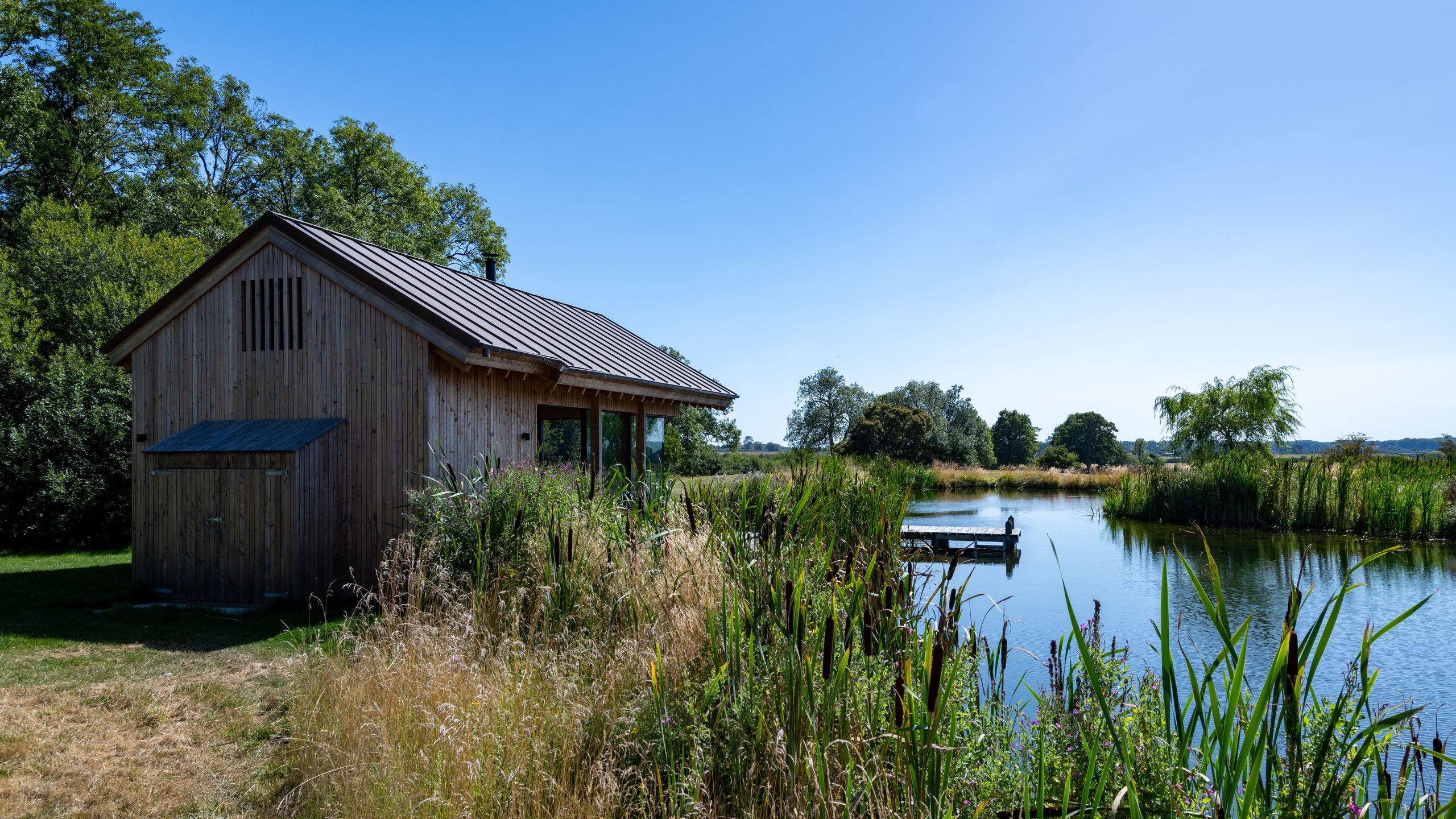 Image may contain: Nature, Outdoors, Scenery, Architecture, Building, Shelter, Pond, Water, Countryside, Hut, and Rural