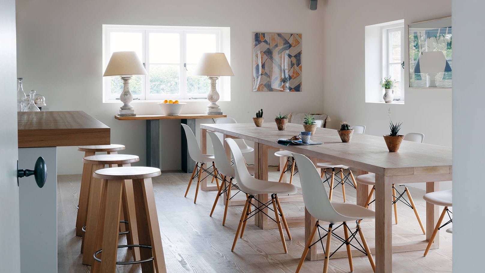 Image may contain: Architecture, Building, Dining Room, Dining Table, Furniture, Indoors, Room, Table, Lamp, Plant, and Chair