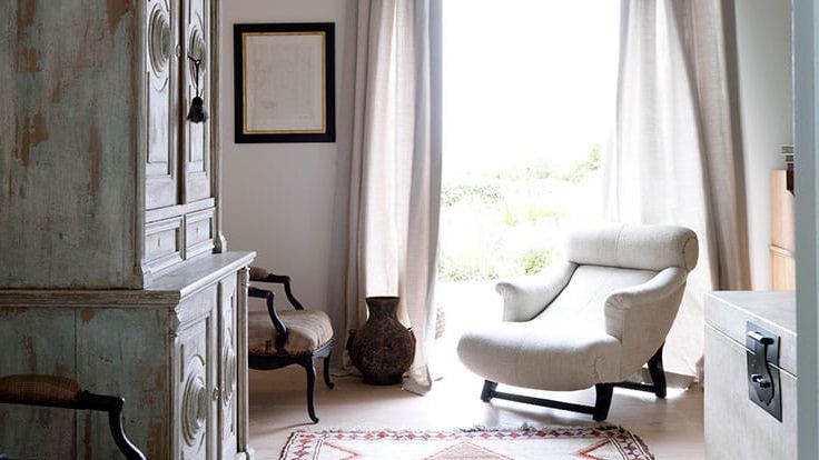 Image may contain: Home Decor, Rug, Chair, Furniture, Art, and Painting