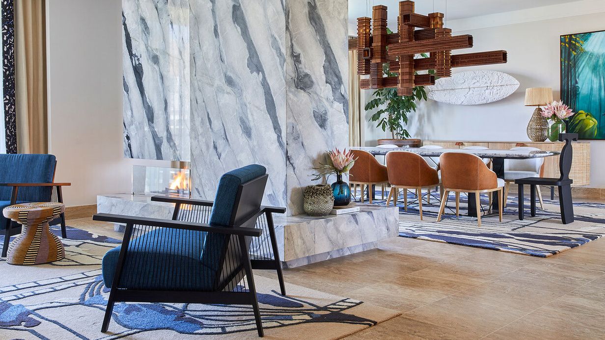 Image may contain: Home Decor, Chair, Furniture, Lamp, Floor, Indoors, Architecture, Building, Foyer, and Interior Design