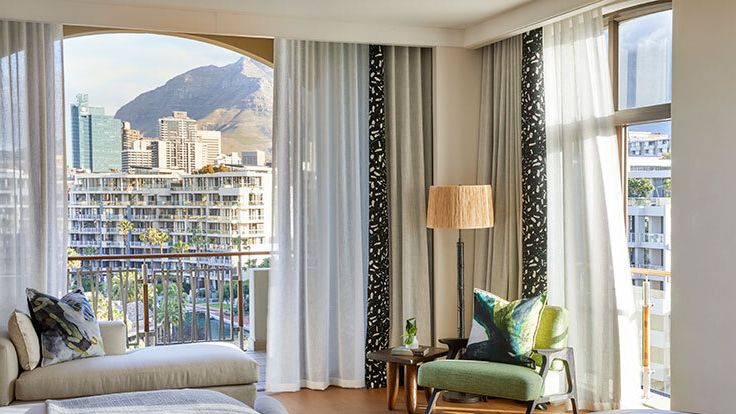 Image may contain: Architecture, Balcony, Building, Lamp, Chair, Furniture, Desk, Table, Couch, Window, and Car