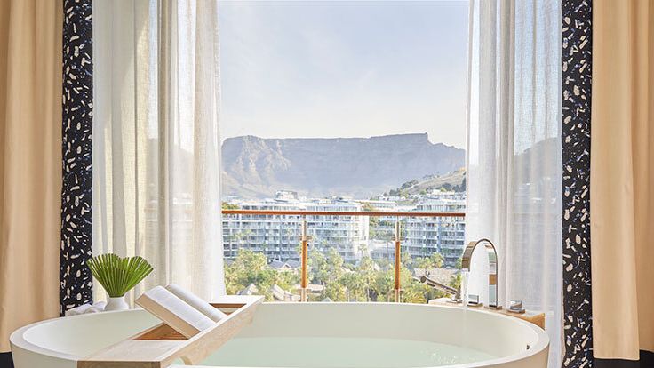 Image may contain: Bathing, Tub, Bathtub, Person, Plant, Sink, and Sink Faucet