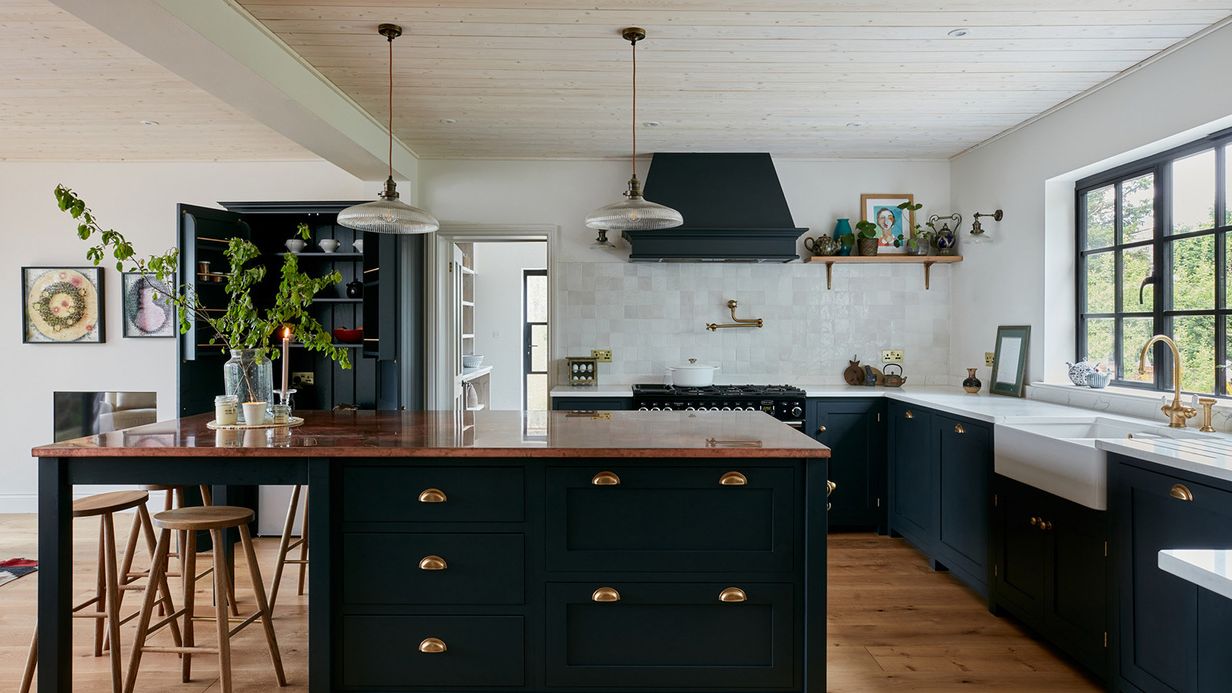 Image may contain: Indoors, Interior Design, Kitchen, Kitchen Island, Lamp, Plant, Furniture, Cup, and Sink