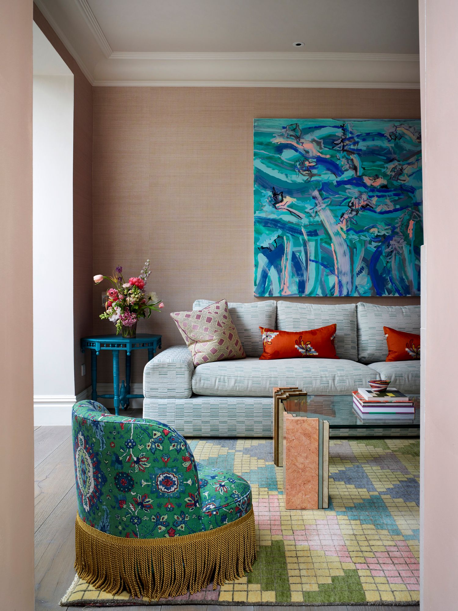 Image may contain: Home Decor, Architecture, Building, Furniture, Indoors, Living Room, Room, Couch, Cushion, Desk, and Table