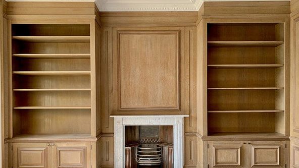 Image may contain: Indoors, Interior Design, Wood, Hardwood, Closet, Cupboard, Furniture, Stained Wood, and Fireplace