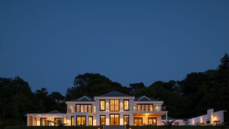 Image may contain: Grass, Plant, Architecture, Building, Housing, House, Villa, Lawn, Water, Waterfront, Manor, and Outdoors