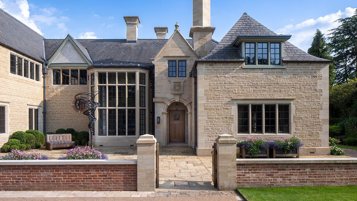 Image may contain: Architecture, Building, Housing, House, Bench, Furniture, Portico, and Manor