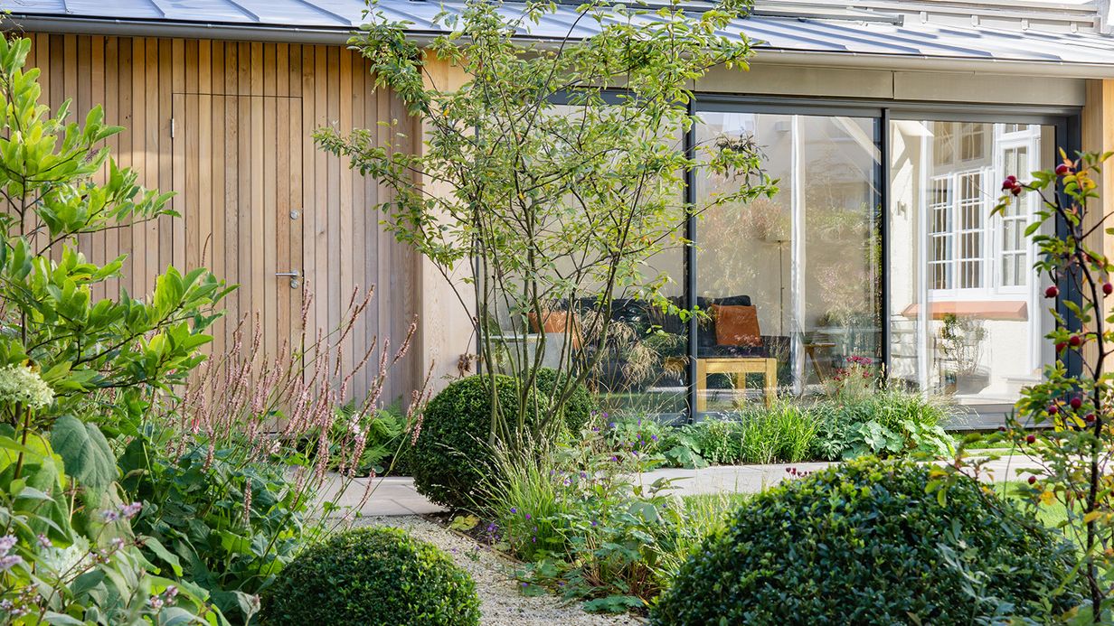 Image may contain: Indoors, Interior Design, Garden, Nature, Outdoors, Backyard, Yard, Chair, Furniture, and Door