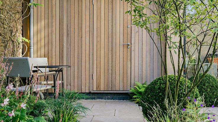 Image may contain: Indoors, Interior Design, Backyard, Nature, Outdoors, Yard, Garden, Grass, Plant, Wood Panels, and Wood