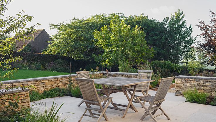 Image may contain: Backyard, Nature, Outdoors, Yard, Desk, Furniture, Table, Chair, Garden, Architecture, Building, and House