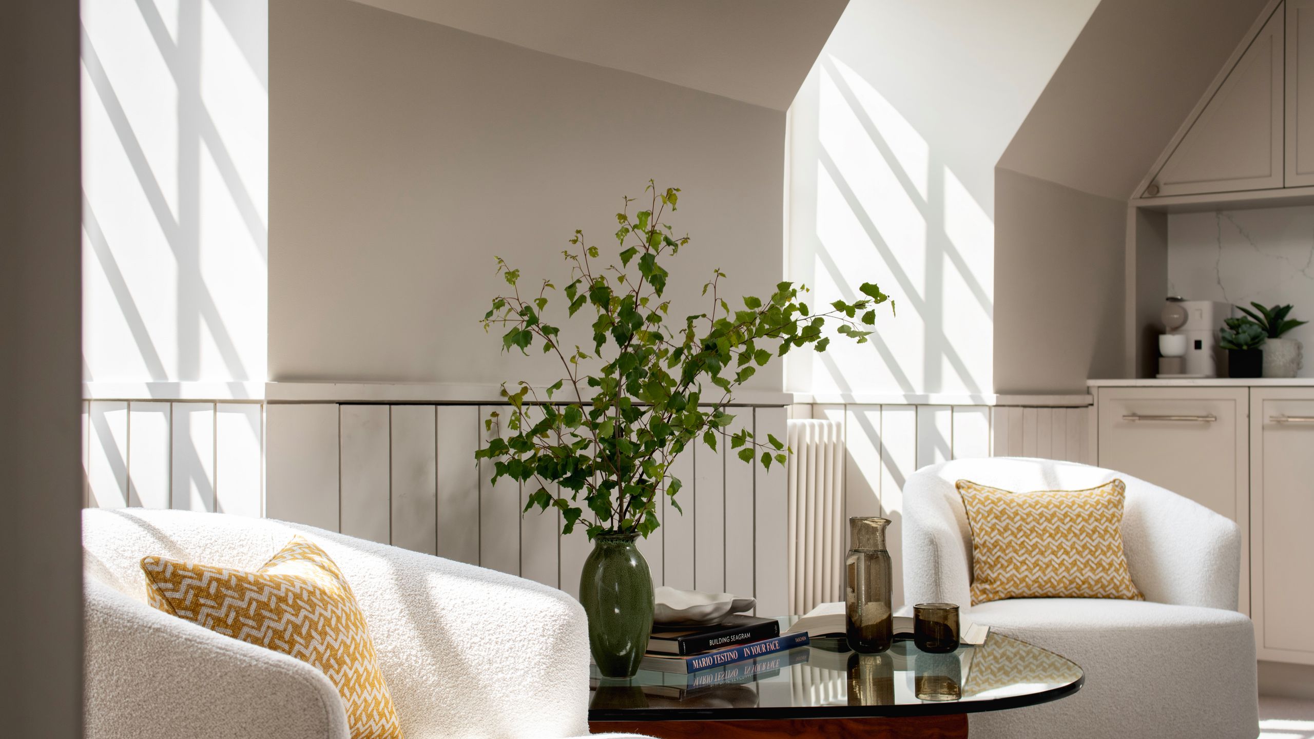 Image may contain: Book, Publication, Architecture, Building, Furniture, Indoors, Living Room, Room, Plant, and Table