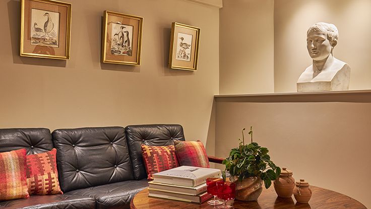 Image may contain: Napoleon, Couch, Furniture, Coffee Table, Table, Architecture, Building, Indoors, Living Room, and Room