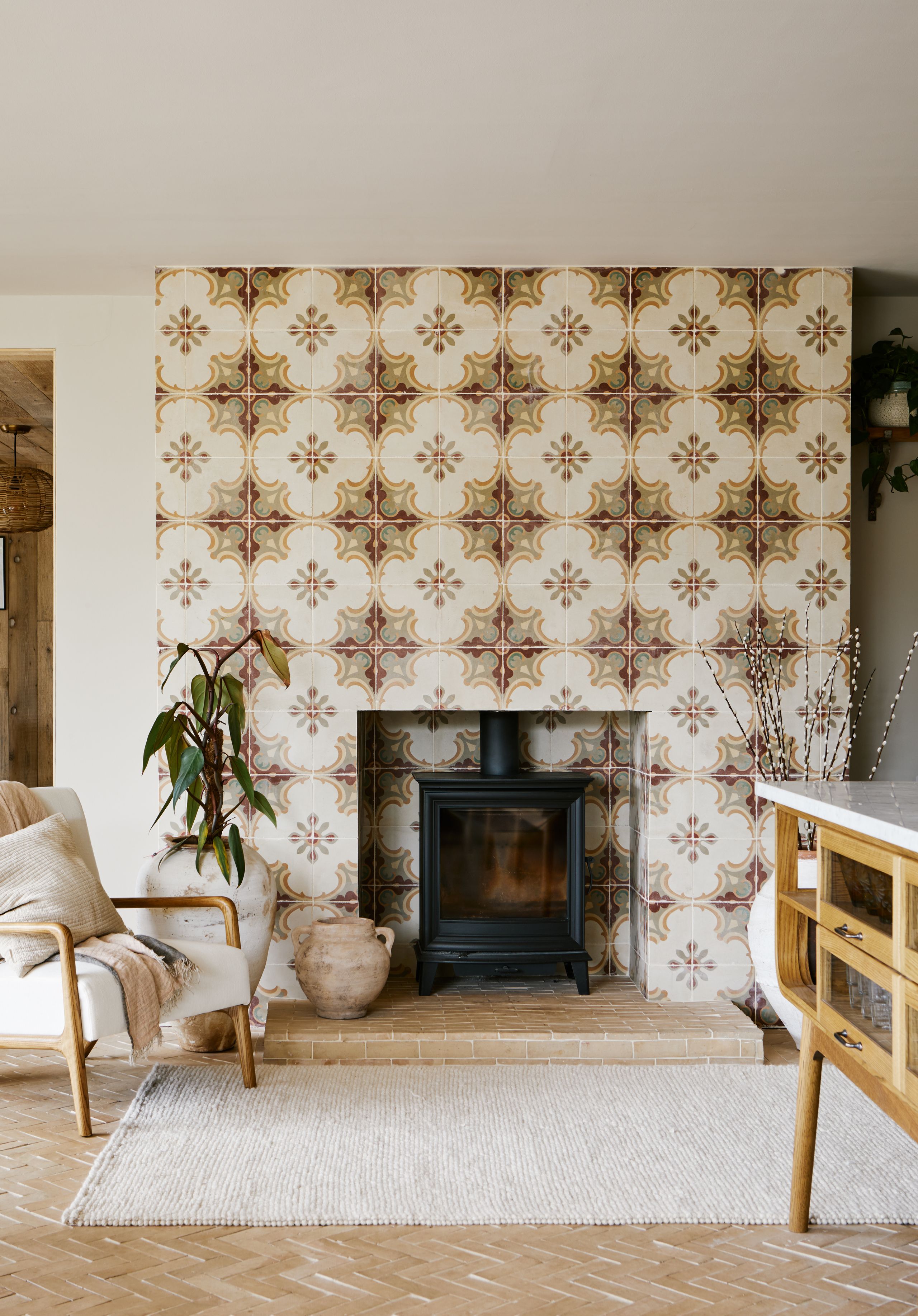 Image may contain: Indoors, Interior Design, Home Decor, Fireplace, Chair, Furniture, Rug, Plant, Architecture, and Building