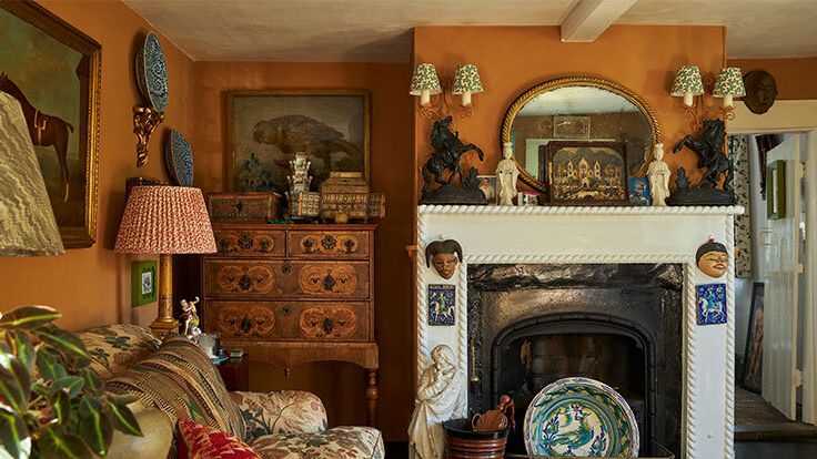 Image may contain: Lamp, Fireplace, Indoors, Plant, Home Decor, Art, Painting, Architecture, Building, and Furniture