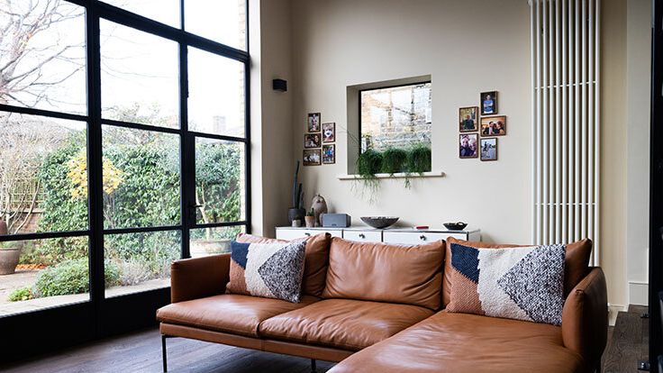 Image may contain: Couch, Furniture, Home Decor, Architecture, Building, Indoors, Living Room, Room, Interior Design, and Rug