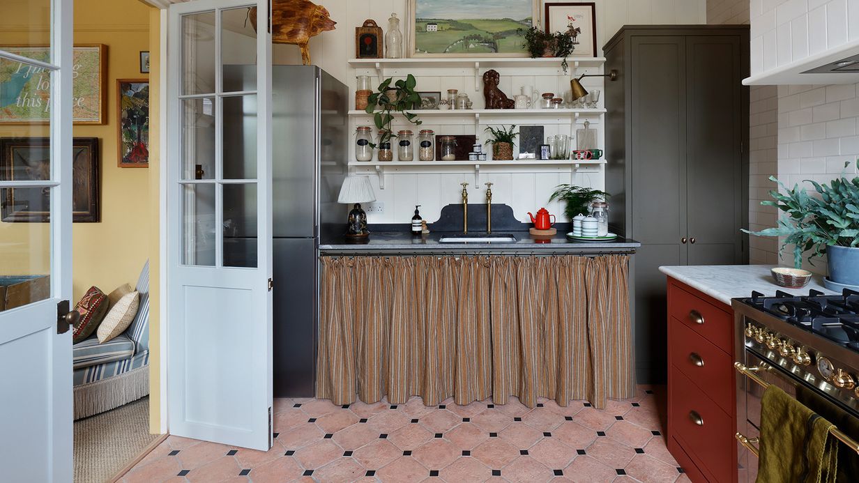 Image may contain: Indoors, Interior Design, Kitchen, Plant, Lamp, Cooktop, Art, Painting, Door, Person, and Home Decor