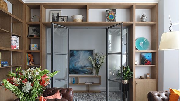 Image may contain: Door, Architecture, Building, Furniture, Indoors, Living Room, Room, Flower, Flower Arrangement, and Plant