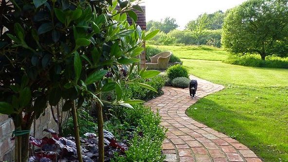 Image may contain: Garden, Nature, Outdoors, Backyard, Yard, Grass, Plant, Chair, Furniture, Architecture, and Building