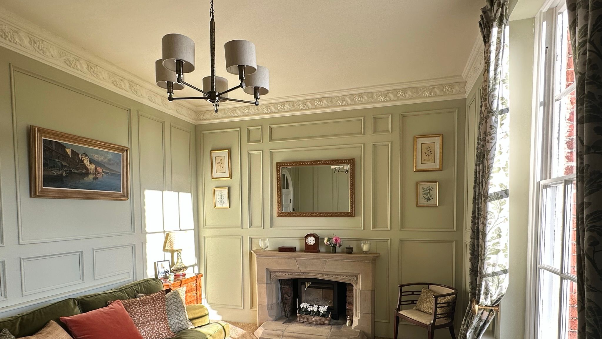 Image may contain: Lamp, Home Decor, Chair, Furniture, Couch, Art, Painting, Fireplace, Indoors, Architecture, and Building