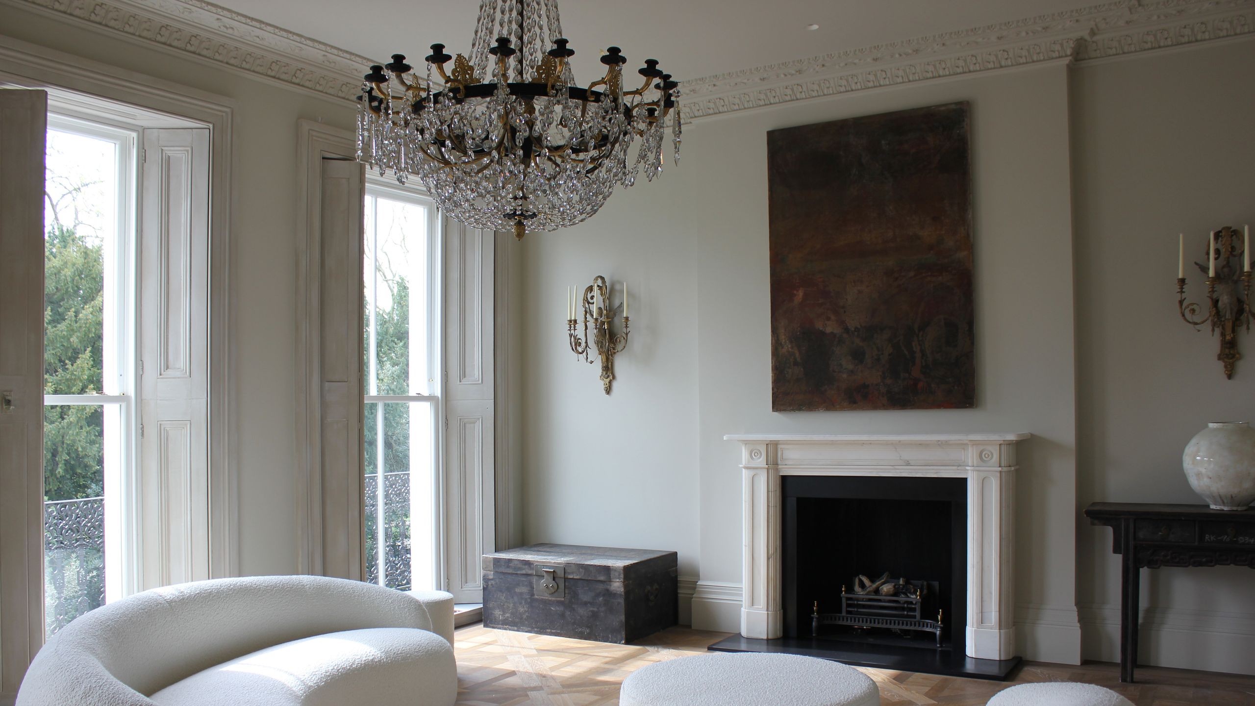 Image may contain: Chandelier, Lamp, Fireplace, Indoors, Architecture, Building, Furniture, Living Room, Room, and Couch