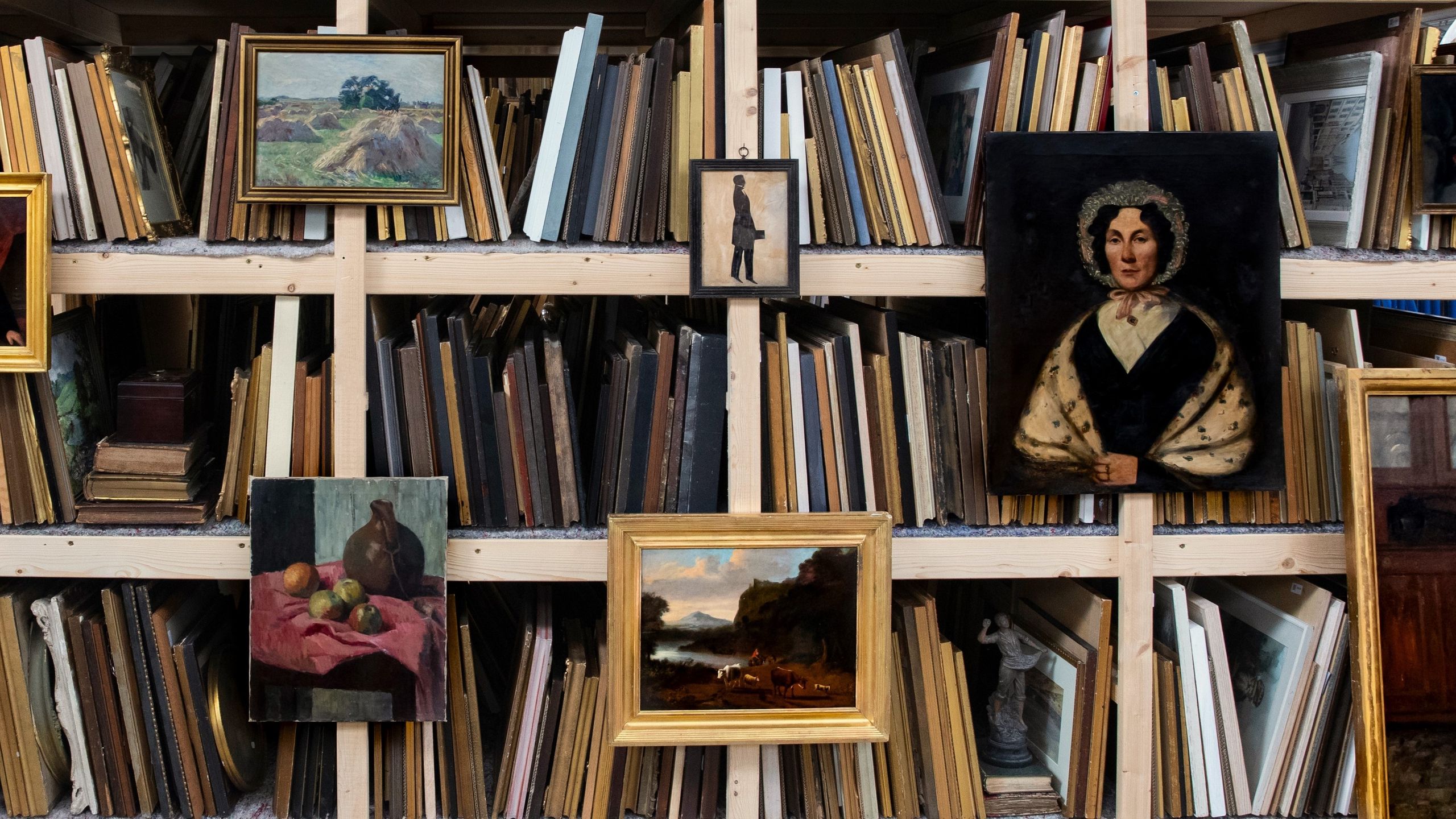 Image may contain: Nicolaus Copernicus, Furniture, Adult, Person, Art, Painting, Bookcase, Book, Indoors, and Library