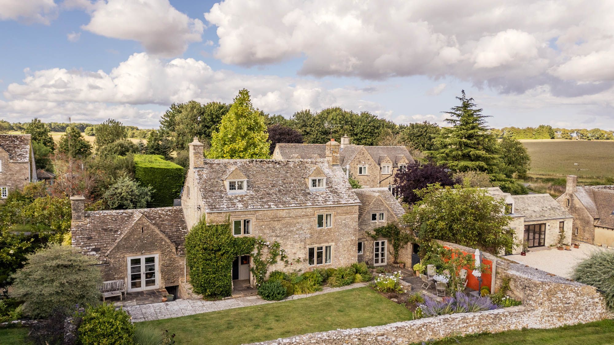 Image may contain: Architecture, Building, Housing, House, Manor, Bench, Furniture, and Outdoors