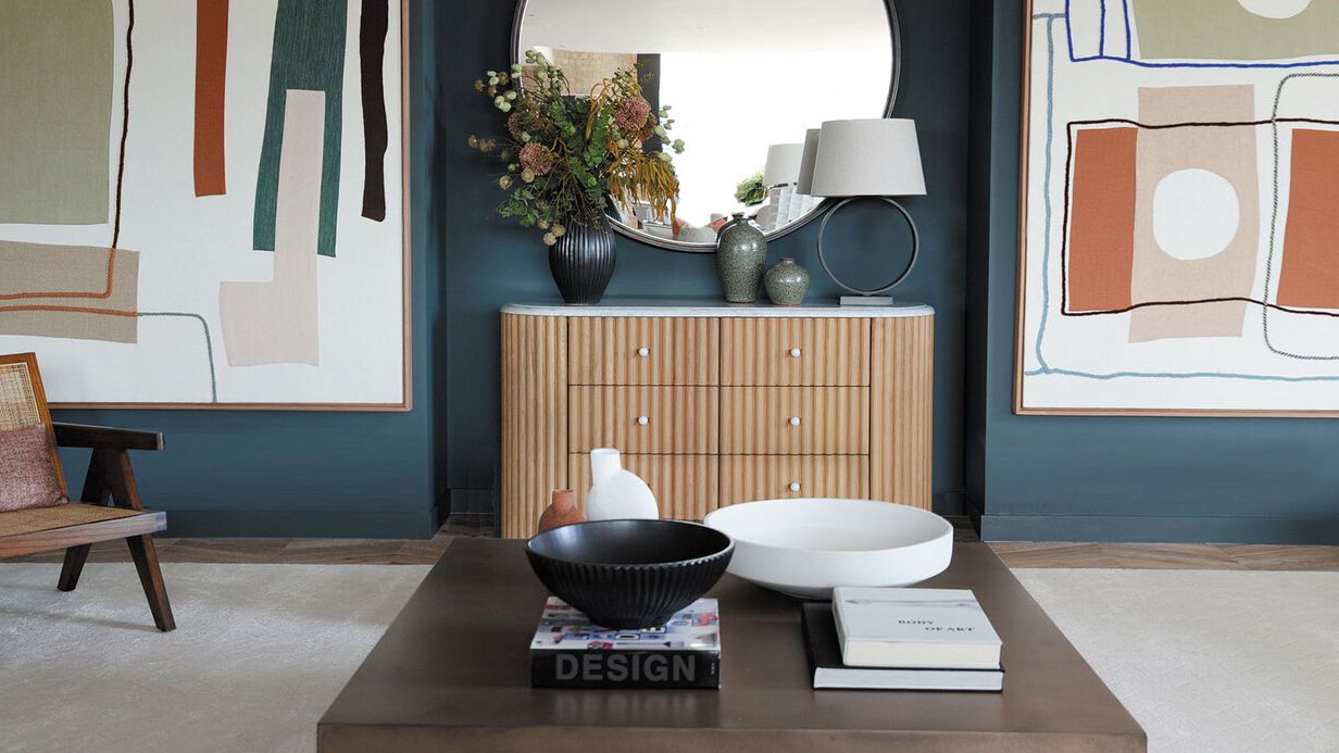Image may contain: Coffee Table, Furniture, Table, Sink, Lamp, Indoors, Interior Design, Chair, Book, and Publication