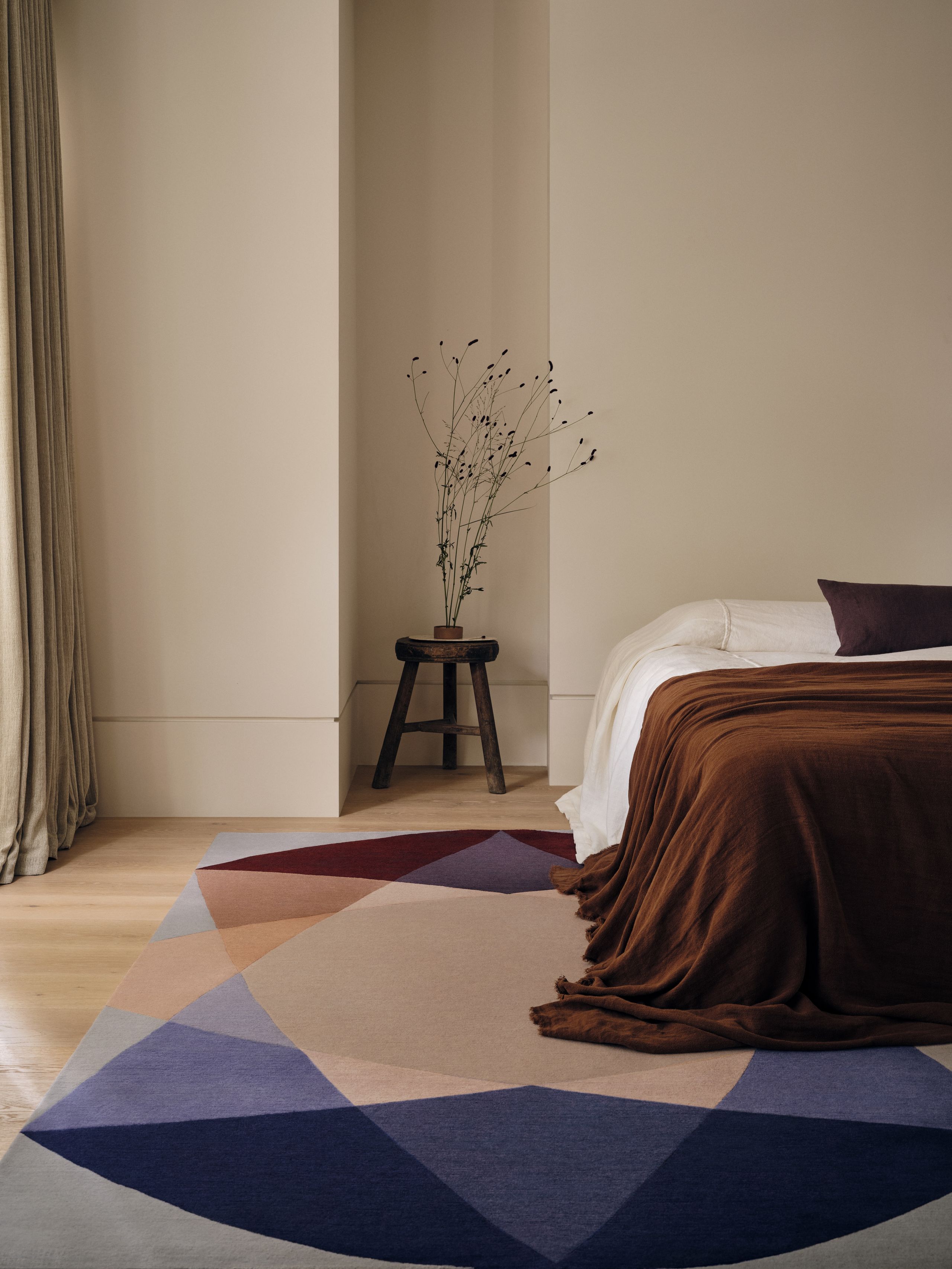 Image may contain: Home Decor, Rug, Bed, Furniture, Plant, Flower, Flower Arrangement, and Ikebana