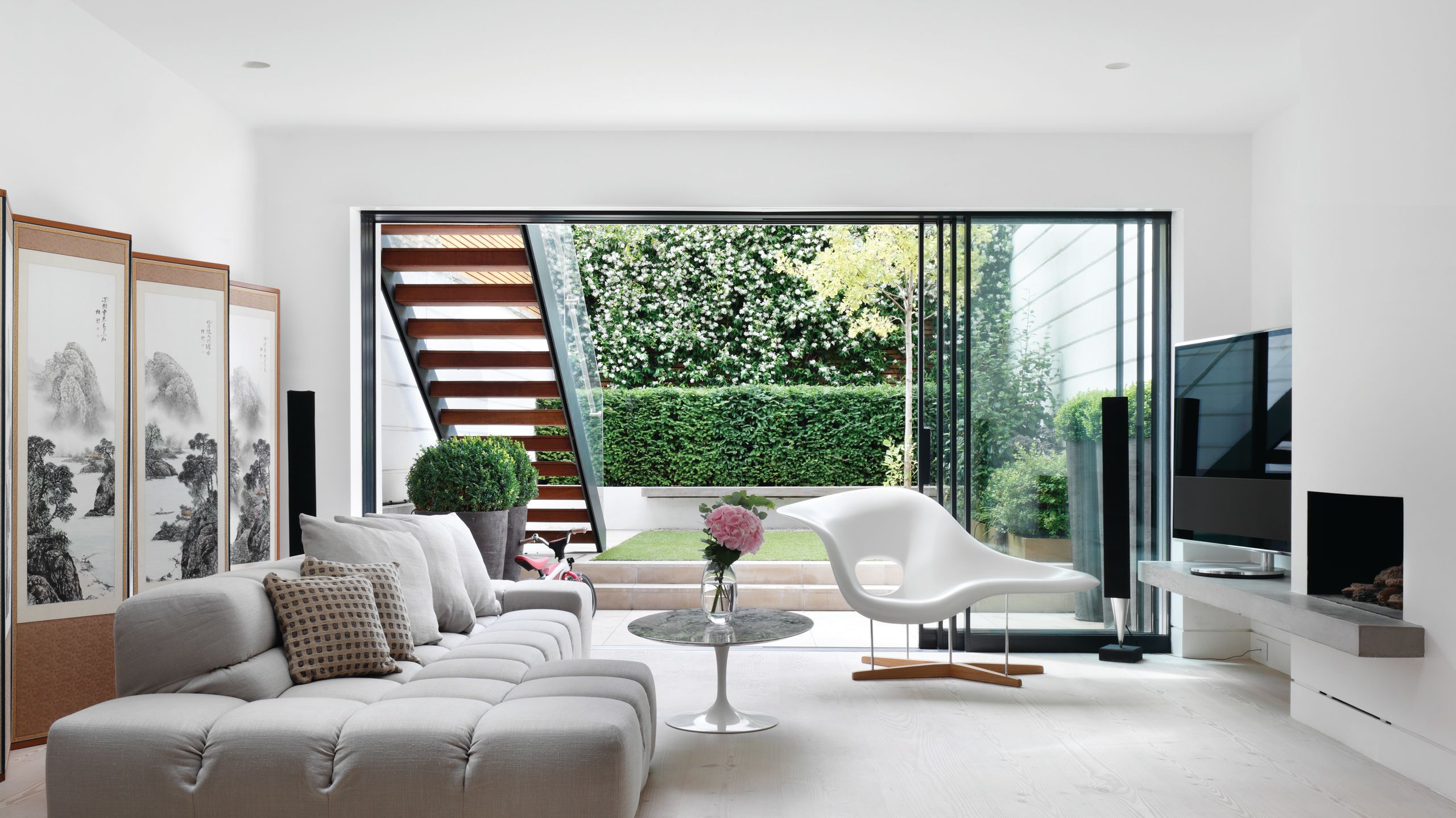 Image may contain: Architecture, Building, Furniture, Indoors, Living Room, Room, Plant, Chair, Home Decor, and Couch