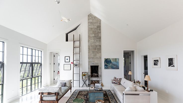 Image may contain: Home Decor, Lamp, Rug, Architecture, Building, Furniture, Indoors, Living Room, Room, Couch, and Table