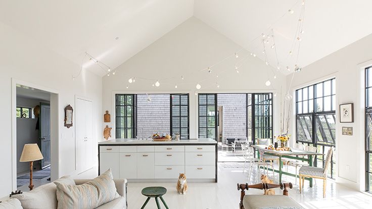 Image may contain: Home Decor, Lamp, Couch, Furniture, Table, Chair, Architecture, Building, Indoors, Living Room, and Room